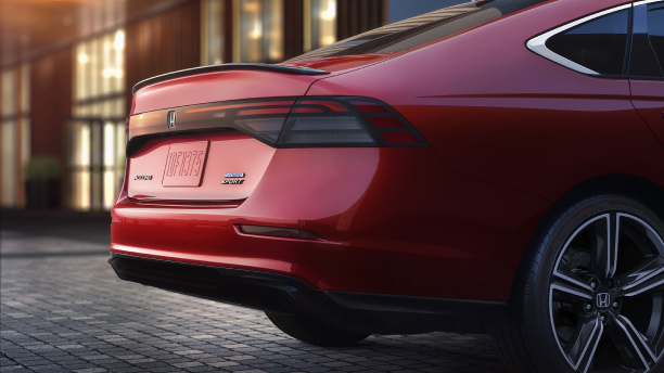 Closeup 3/4 view of the trunk and back wheel fender on a red Accord.
