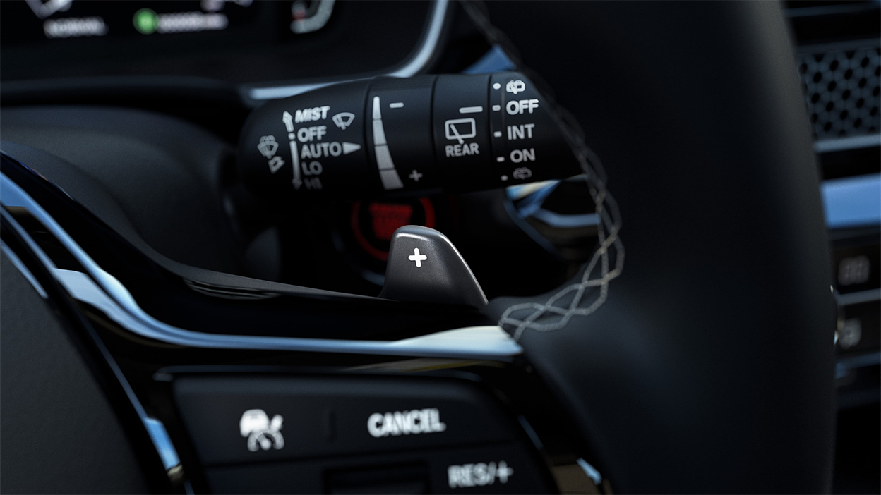 Closeup of cruise control button on the steering wheel.
