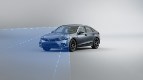 3/4 front view of grey Civic Hatchback. Blue sensor waves and lines emit from the front.