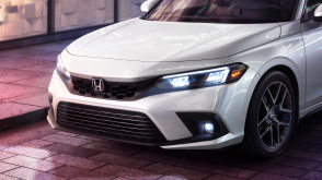 3/4 closeup of the front of a white Hatchback. 