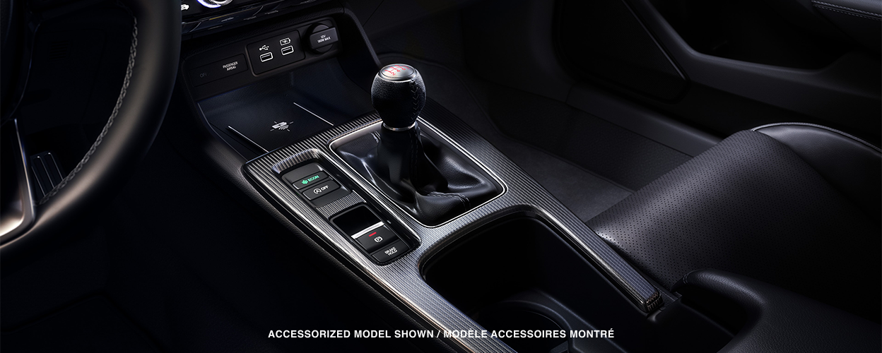 Closeup of gear shifter and cupholder console.