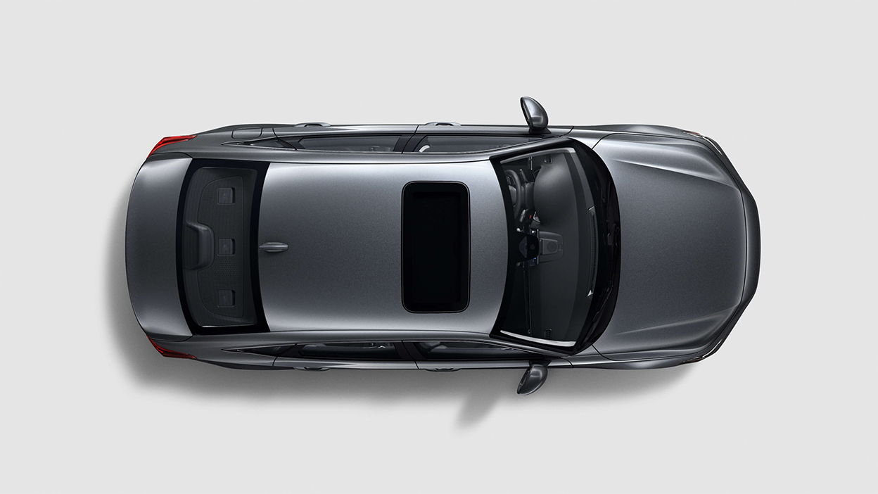 Bird’s eye view looking directly down at a grey Civic Sedan on white space.