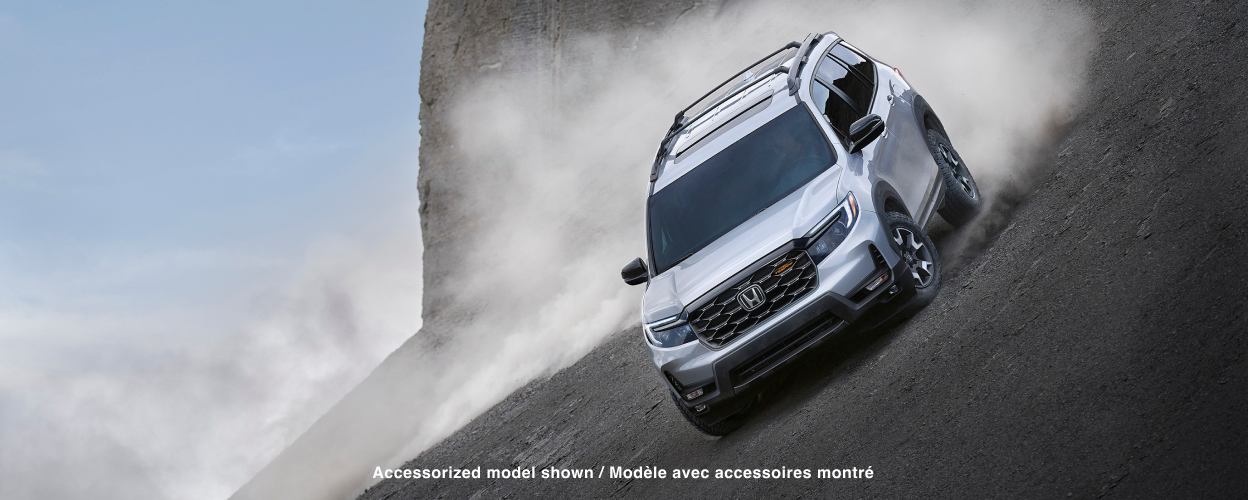 3/4 front view of grey Passport off-roading in desert.