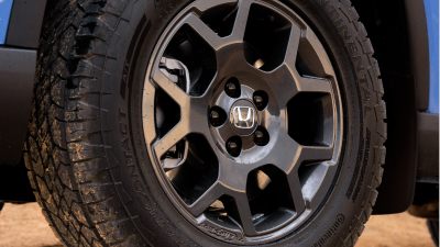 Closeup of black wheels on a light Pilot in the desert.